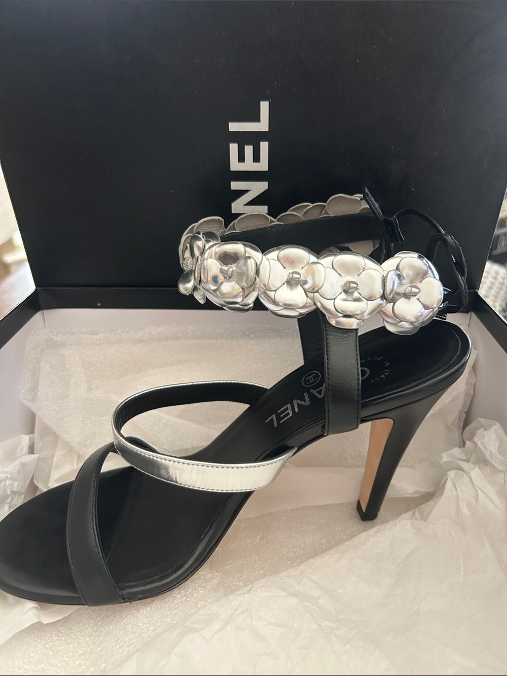 CHANEL Black Leather High Heel Sandal with Silver Camellia Accents